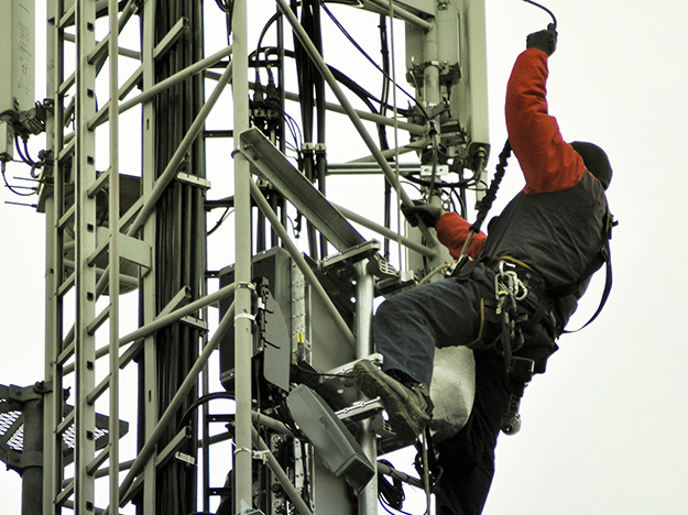 Man climbing radio mast